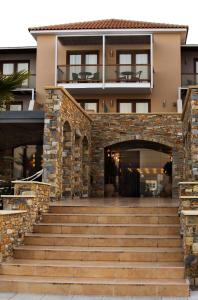 an entrance to a building with stairs in front at Valis Resort Hotel in Volos