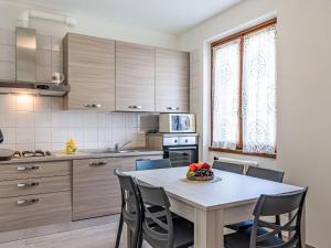 a kitchen with a table and chairs in a room at Apartment Elena by Interhome in Bellano