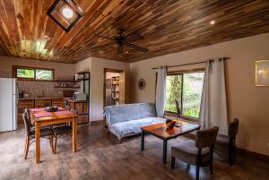 a living room with a couch and a table at Corcovado Private Houses-Villas-Tents-Nature-Relaxing in Puerto Jiménez