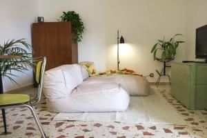 a living room with a bean bag chair and a white couch at Casa Donna Pippina in Villafrati
