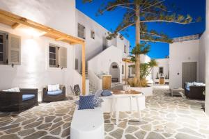 an outdoor patio with a table and chairs at Swell S10 maisonette with private Jacuzzi in Naousa in Naousa