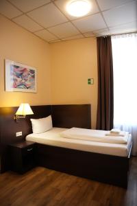 Postel nebo postele na pokoji v ubytování Hotel CityRing