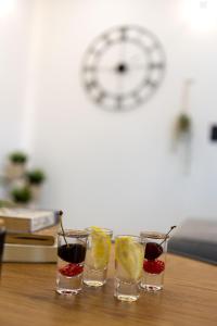 a group of four glasses of drinks on a table at Luxury Apartment SeaYou Kaštela in Kaštela