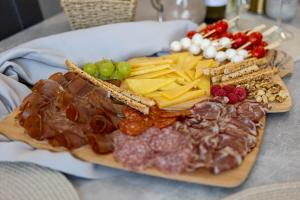 a plate of cheese and crackers and fruit on a table at Luxury Apartment SeaYou Kaštela in Kaštela