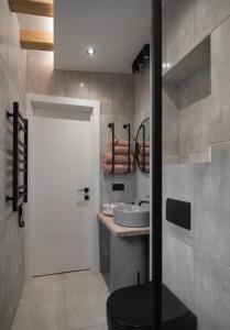 a bathroom with a white door and a sink at Лісогори in Slavske +77 photos