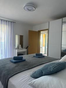 a bedroom with a large bed with blue pillows on it at Apartman Majba 2 in Zaglavice