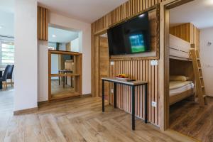 a small room with a tv and bunk beds at Pogacar Apartments in Bled