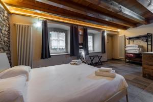 Posteľ alebo postele v izbe v ubytovaní Inn Aosta Apartments