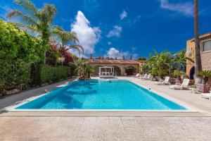 a swimming pool in the backyard of a house at Villa Thalissa by Perle di Puglia in Taranto