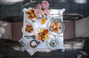 a white table with breakfast foods on it at Boutique Hotel Townhouse 27 in Belgrade