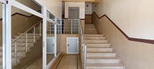 a staircase in a building with two white doors at Nour 2 in Oued Laou