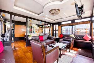 a living room with a couch and a table at Northstar 5 Bedroom Ac Private Houseboat With All Meals in Alleppey