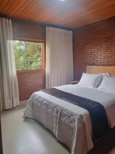 Postel nebo postele na pokoji v ubytování Casa na Rampa - Hospedagem no Caravaggio