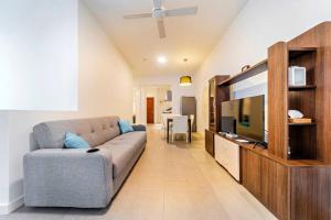 a living room with a couch and a flat screen tv at 2 Bedrooms- Ebene Square in Ebene