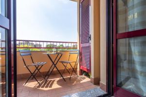 a balcony with two chairs and a table at GuestHost - Casa Le Palme in Pioltello
