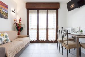 a living room with a couch and a table at GuestHost - Casa Le Palme in Pioltello