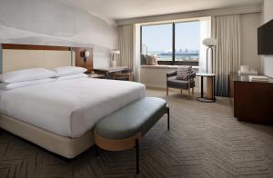 长滩Marriott Long Beach Downtown的一间带床和大窗户的酒店房间