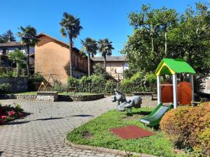 a park with a playground with a elephant and a slide at Appartamento IL Tulipano in Brezzo