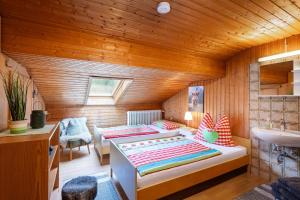 a bedroom with a bed and a sink in a room at Ferienwohnungen „Zum Bauern“ in Oberaudorf