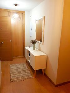 a bathroom with a white dresser and a mirror at Taboada Sacra Home in Taboada