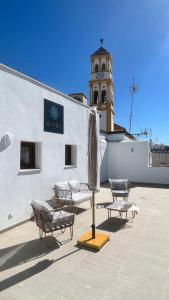 a building with a clock tower on top of it at Selecta Marbella Sentire Apartaments in Marbella