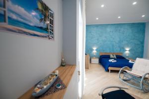 a room with a bedroom with a bed and a couch at Camerelle Apartments - casa vacanze in Castellammare di Stabia +48 photos