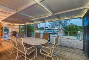 een eetkamer met een tafel en stoelen op een terras bij Island Sea-Cret in Anna Maria