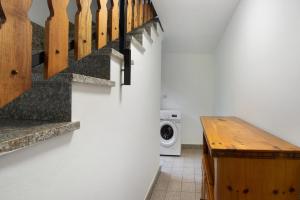 a laundry room with a washing machine next to a staircase at Luéisch Ketschu near Gressoney in Issime +39 photos