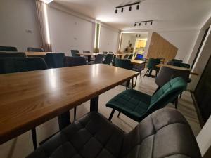 a conference room with a wooden table and chairs at Pensiunea Lotus Corbu in Corbu
