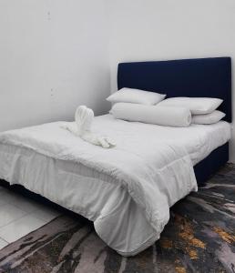 a bed with white sheets and pillows on it at AZ homestay KLIA in Banting