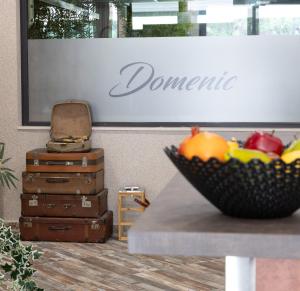 a bowl of fruit on a table in front of a sign at Hotel Domenic FREE PARKING in Plovdiv