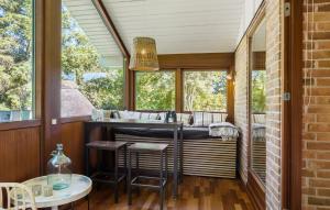 a kitchen with a sink and a table and chairs at Awesome Home In Græsted With Sauna in Græsted