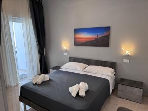 a bedroom with a bed with two towels on it at B&B Primalba in Otranto