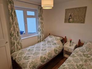 Ένα ή περισσότερα κρεβάτια σε δωμάτιο στο Rosecraddoc Lodge 23