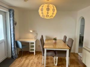 a dining room with a table and chairs and a lamp at Rosecraddoc Lodge 23 in Liskeard