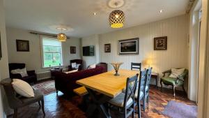 a living room with a table and a couch at O'Hares Farmhouse in Tassagh