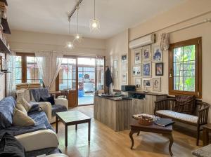 a living room with a couch and a table at Kekik Butik Otel in Çeşme