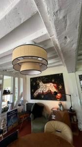 a living room with a chandelier hanging from a ceiling at Gîtes et Spa en Normandie in Sainte-Marguerite-de-Viette +66 photos