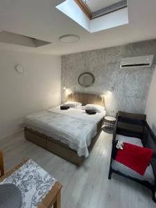a bedroom with a bed and a chair in it at Apartments Oliva in Poreč