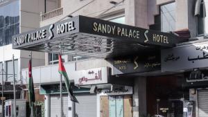 a sign for sammy palace hotel on the side of a building at Sandy palace Hotel in Amman