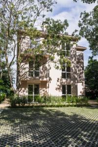 an old building with a tree in front of it at Garden Apartment Fichoza 2 - 80m from the sea in Varna City