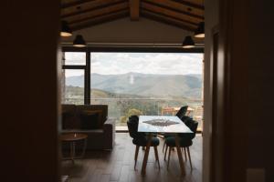 a living room with a table and chairs and a view at Quinta da Malhada in Cabril