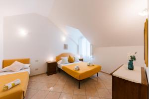 Postel nebo postele na pokoji v ubytování Tramonti Resort + 37 fotografií