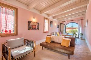 a living room with a couch and a chair at ISA-Chalet with common swimming-pool surrounded by Tuscan nature in Trequanda +12 photos