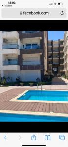 a picture of a building with a swimming pool at Residence amwej sousse in Sousse
