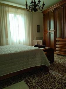 a bedroom with a bed and a large window at Podere Gian Battaglia in Fucecchio