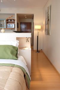 a bedroom with a bed and a lamp in a room at Concord Callao by Recoleta Apartments in Buenos Aires
