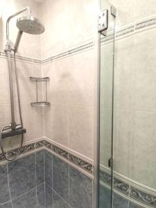 a shower with a glass door in a bathroom at Mountain View Beach House in Costa da Caparica +8 photos