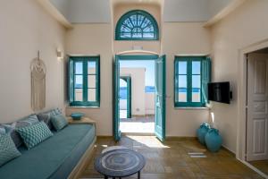 a living room with a couch and a window at Passion Blue Villas in Oia