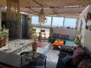 a living room with a couch and a table at Amazigh surf house in Agadir
